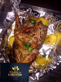 A picture of Oven Grilled full Chicken with garnish.