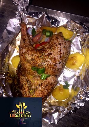 A picture of Oven Grilled full Chicken with garnish.