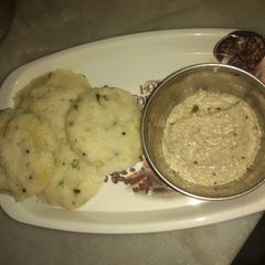 A picture of Vegetable idli with peanut coconut chutney.