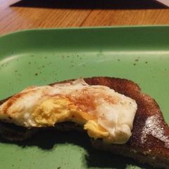 A picture of Cooked eggs w/toast.