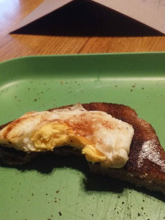 A picture of Cooked eggs w/toast.
