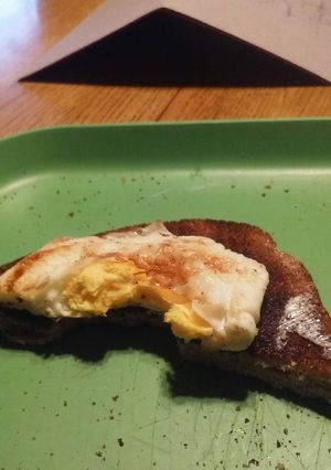 A picture of Cooked eggs w/toast.