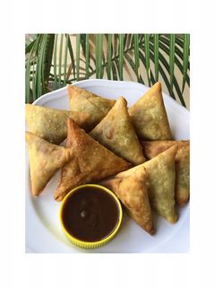 A picture of Samosa and a chutney.
