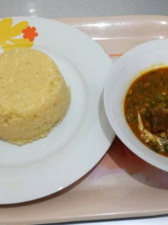 A picture of Okro soup with yellow garri.