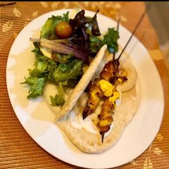 A picture of Yellow chicken skewers.