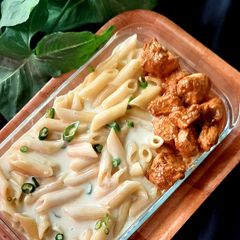 A picture of Volcanic chicken with white sauce pasta.