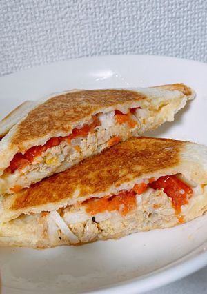 A picture of Toasted Sandwich with Tomato, Cabbage and Tuna.