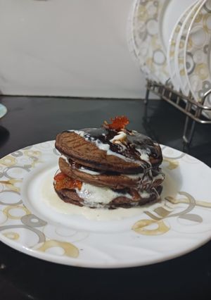 A picture of Choco banana pancakes With Orange Marmalade and Fresh cream.