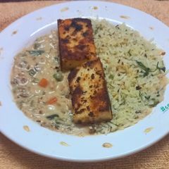 A picture of Paneer Steak with Herbed Rice and Creamy Veggies.