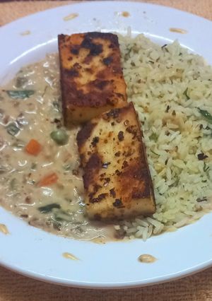 A picture of Paneer Steak with Herbed Rice and Creamy Veggies.