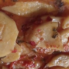A picture of Red sauce with potatoes.