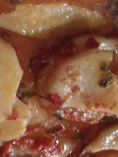 A picture of Red sauce with potatoes.