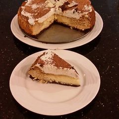 A picture of Vanilla / Peanut Butter Ice Cream Cake with a Crispy Crust and Whipped Cream Topping With Creamy Crispy Chicolate Bark.