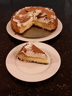 A picture of Vanilla / Peanut Butter Ice Cream Cake with a Crispy Crust and Whipped Cream Topping With Creamy Crispy Chicolate Bark.