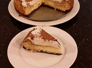 A picture of Vanilla / Peanut Butter Ice Cream Cake with a Crispy Crust and Whipped Cream Topping With Creamy Crispy Chicolate Bark.