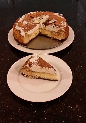 A picture of Vanilla / Peanut Butter Ice Cream Cake with a Crispy Crust and Whipped Cream Topping With Creamy Crispy Chicolate Bark.