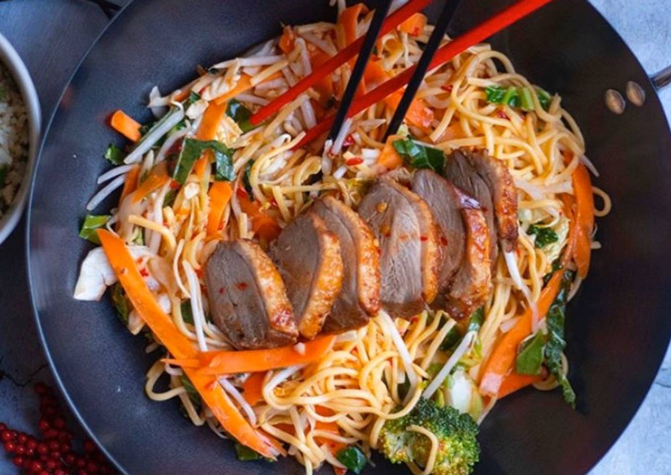 Fried egg noodles with duck fried in sweet plum sauce