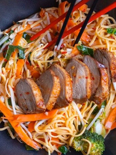 A picture of Stir fried egg noodles with roasted duck in sweet chilli plum sauce.