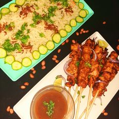 Chicken satay with peanut sauce and mixed vegetable rice A picture of Chicken satay with peanut sauce and mixed vegetable rice.