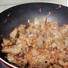 A picture of Brown peanut butter rice with wet fry liver.