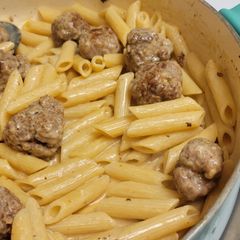 A picture of Penne with pork meatballs.