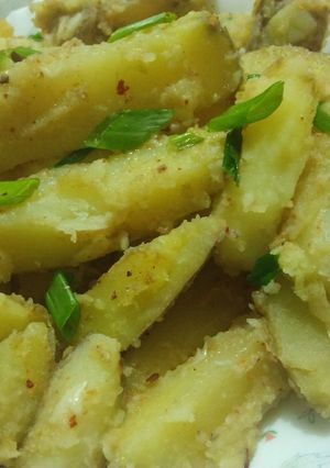A picture of Garlic buttery potato wedges.