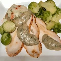 A picture of Roasted turkey breast, tarragon gravy, Blanched and sautéed Brussels sprouts,.