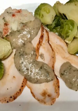 A picture of Roasted turkey breast, tarragon gravy, Blanched and sautéed Brussels sprouts,.