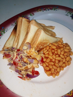 A picture of Toasted Bread with Fried Eggs and Baked Beans.