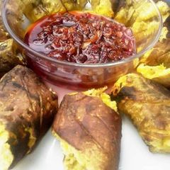 A picture of Roasted plantain with palmoil sauce.