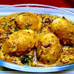 A picture of Egg Malai Curry with coconut and yogurt sauce.