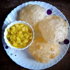 A picture of Aloo sabji with puri.