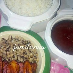 A picture of Rice and stew with beans and plantain.