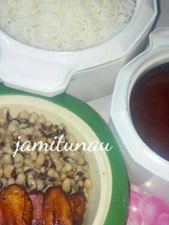 A picture of Rice and stew with beans and plantain.