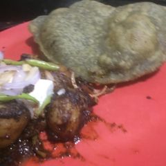 A picture of Pindi chana & palak bhatura.