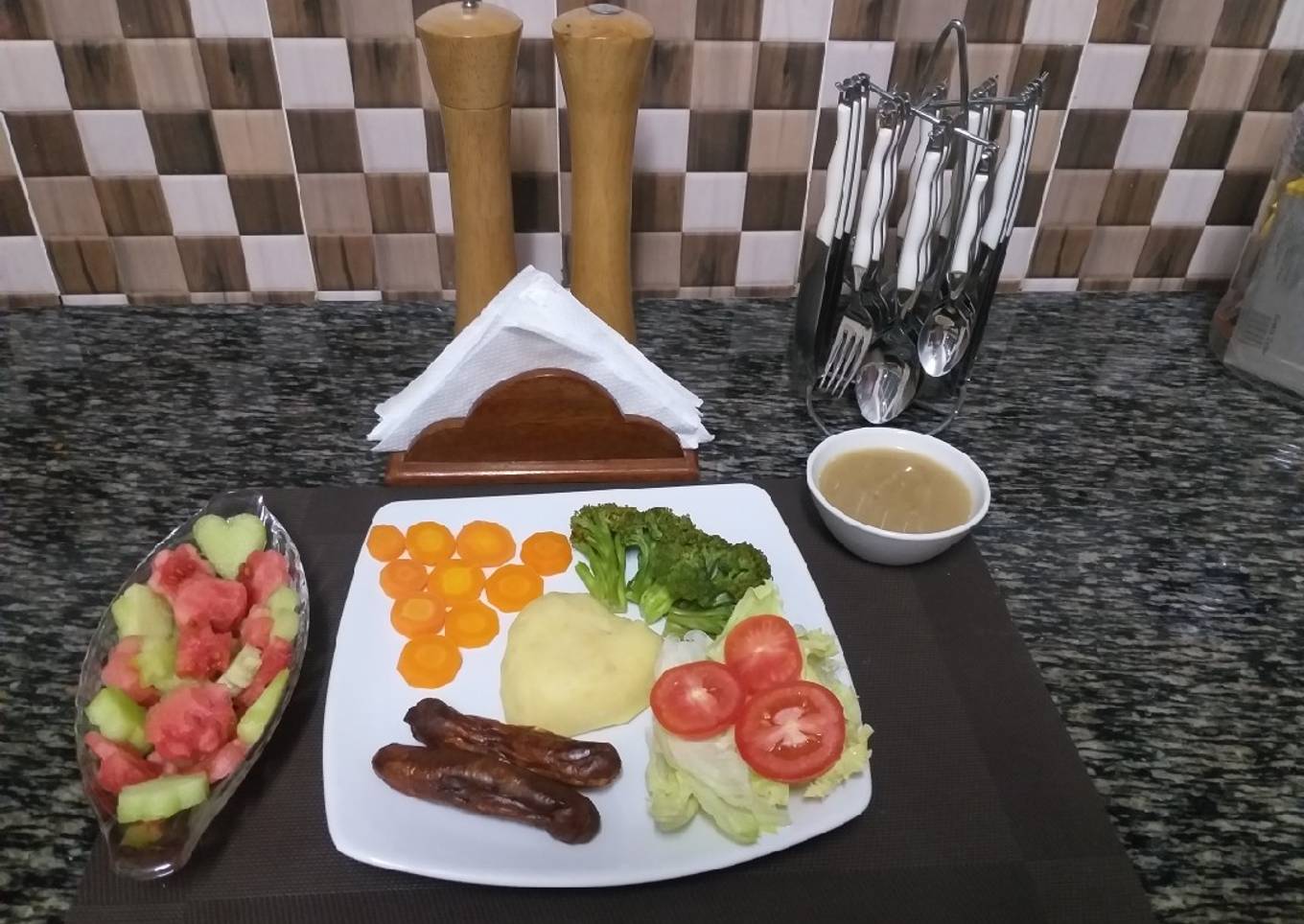 Mash Potatoes with some steamed veggies,sausages,fruit salad