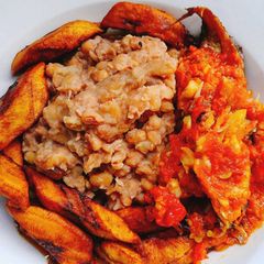 A picture of Beans with fried plantain and sauce.