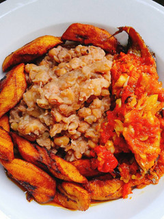 A picture of Beans with fried plantain and sauce.