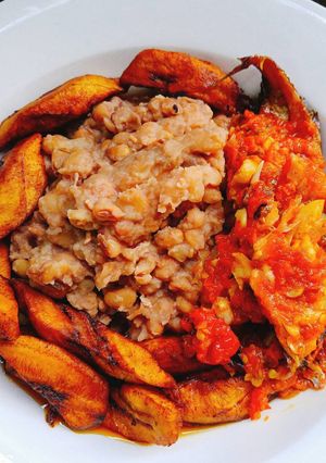 A picture of Beans with fried plantain and sauce.