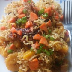 A picture of Jollof Indomie with dry Fish and plantain.