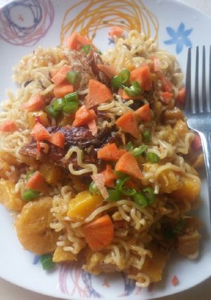 A picture of Jollof Indomie with dry Fish and plantain.