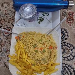 A picture of Indomie noodles and potatoes chips.