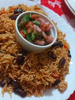 A picture of Mexican Beans Rice with salsa.