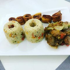 A picture of Coconut rice with fried plantain and beef.
