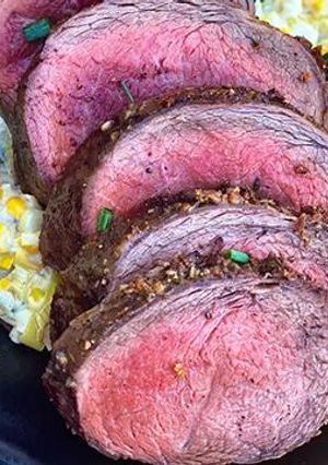 A picture of Garlic-Rubbed Wagyu Teres Major Roast with Creamed Leeks and Corn.