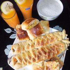 A picture of Caterpillar bread,ginger juice with mango and fura.
