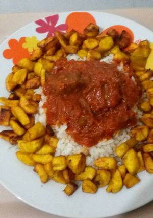 A picture of Ofada Rice with fried plantain and beef.