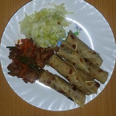 Beef served with chapati and steamed cabbage A picture of Beef served with chapati and steamed cabbage.