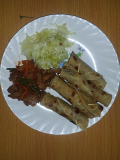 A picture of Beef served with chapati and steamed cabbage.