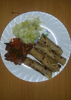 A picture of Beef served with chapati and steamed cabbage.